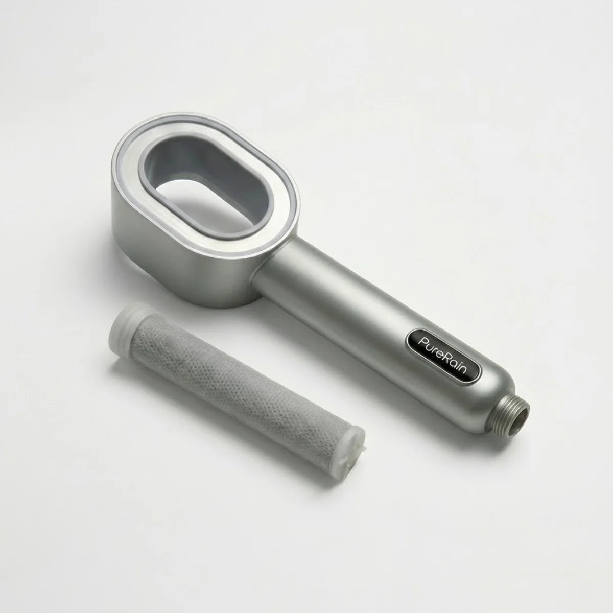 Silver handheld filtered shower head on a white background pictured next to a filter that is normally inside the showerhead, featuring the 'PureRain' brand.